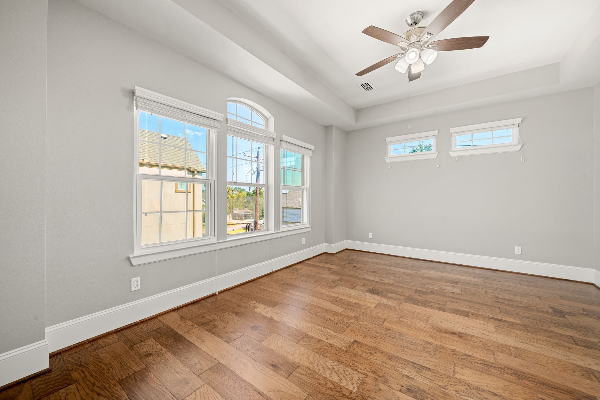 6703 Highclere Manor Lane Houston, TX 77055 - Photo 25 of 36 a view of an empty room with a window and a chandelier fan