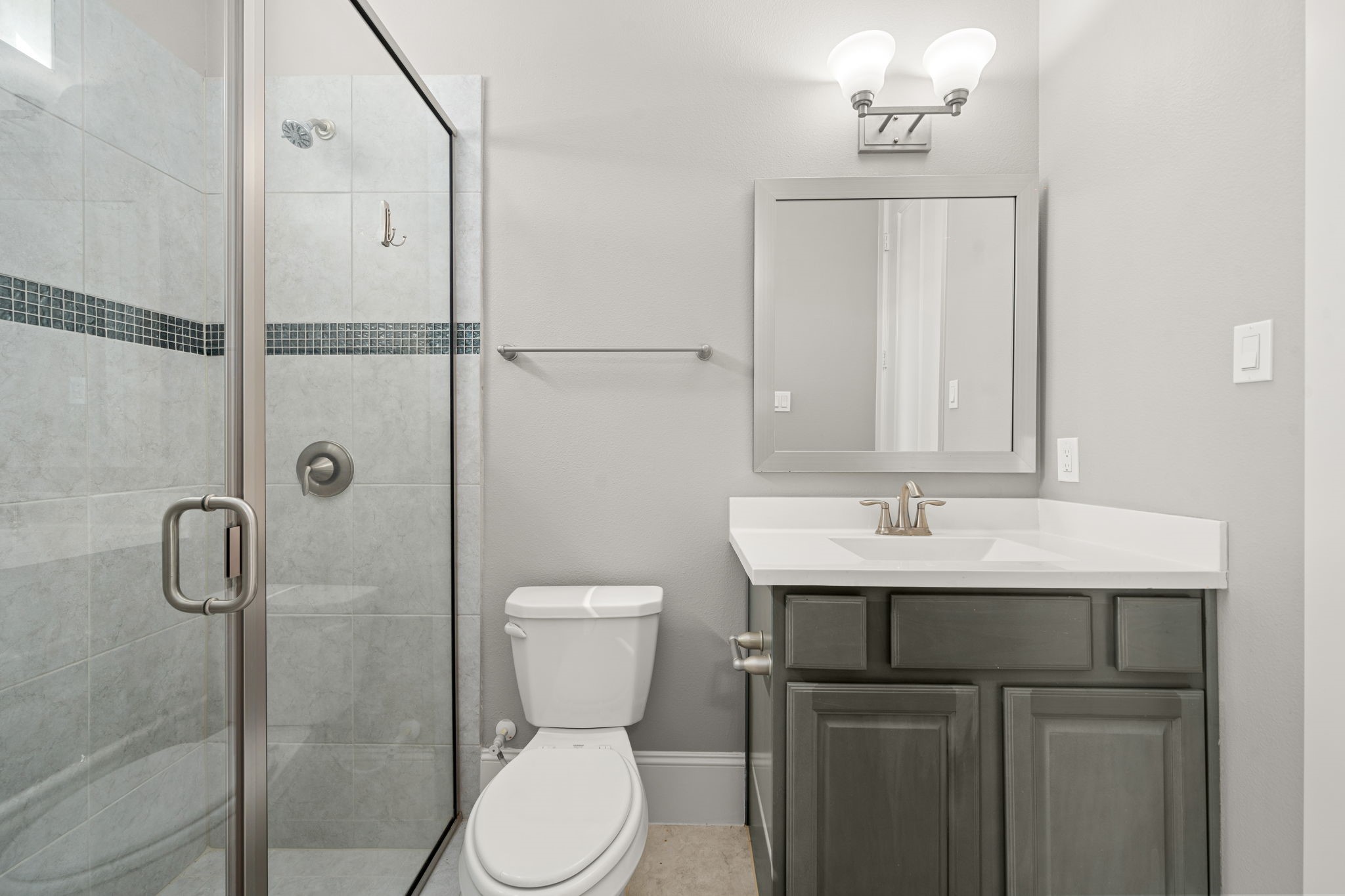 6703 Highclere Manor Lane Houston, TX 77055 - Photo 8 of 36 a bathroom with a toilet a sink a mirror and shower