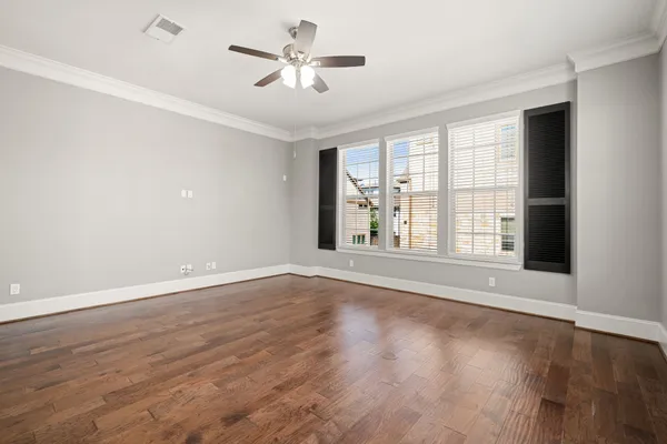 wooden floor in an empty room with a window
