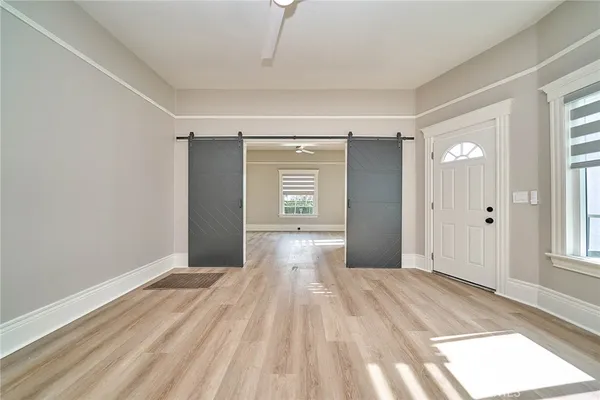 a view of a livingroom with wooden floor and a window