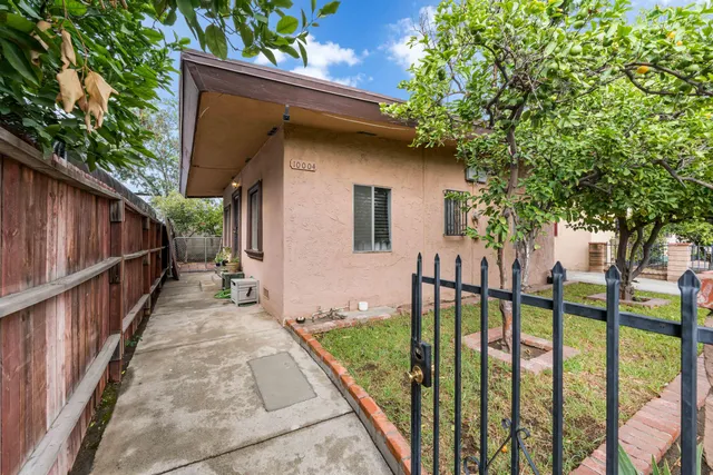 a view of a house with wooden fence