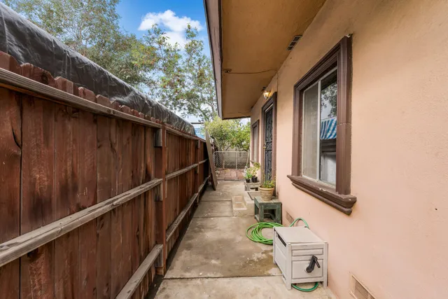 a balcony with wooden floor and outdoor space