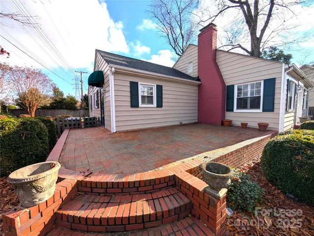 a backyard of a house with yard and outdoor seating