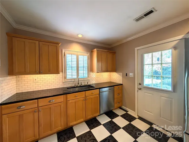 a kitchen with stainless steel appliances granite countertop a sink and cabinets
