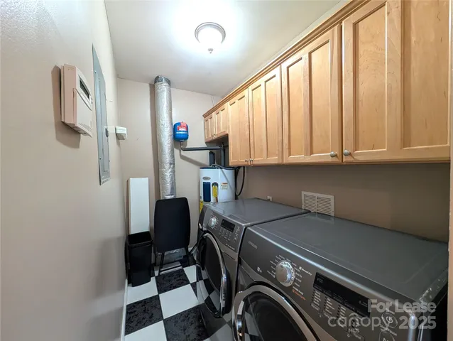 a view of storage and utility room with stainless steel appliances wooden floor and view living room