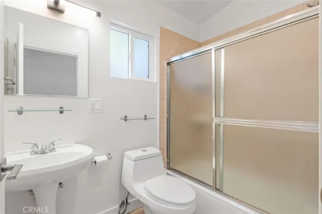 a bathroom with a sink a mirror and a toilet