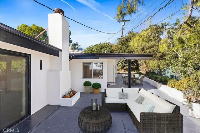 a view of a patio with couches chairs and potted plants