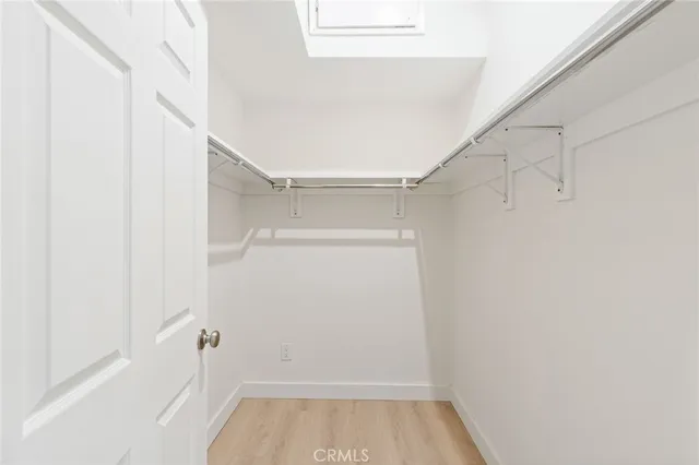 a view of walk in closet with empty racks