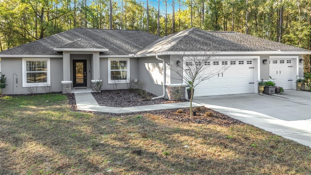 13378 Southwest 61st Place Road Ocala, FL 34481 - Photo 1 of 1 a front view of a house with garden