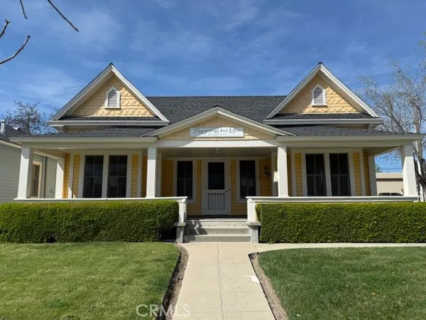 a view of a house with garden and porch