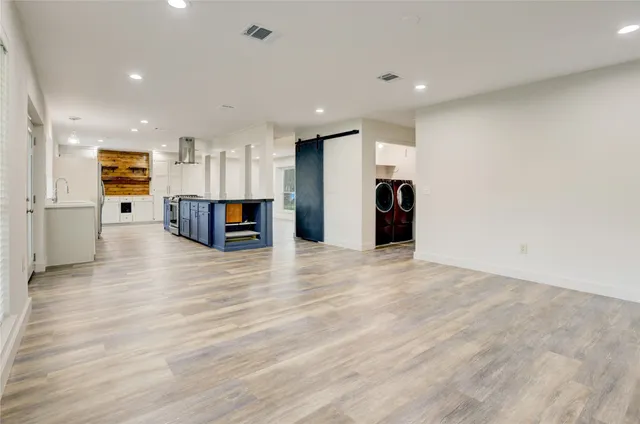 a view of a kitchen with a refrigerator and a stove top oven