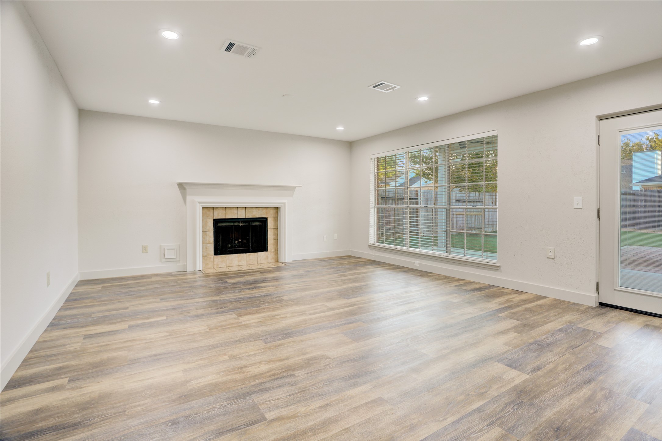 3122 Rimrock Drive Missouri City, TX 77459 - Photo 15 of 29 a view of an empty room with wooden floor and a window