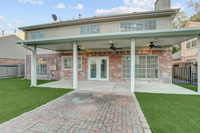 a view of a porch with a big yard and large trees