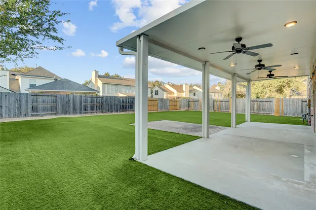 a view of an house with backyard space and balcony