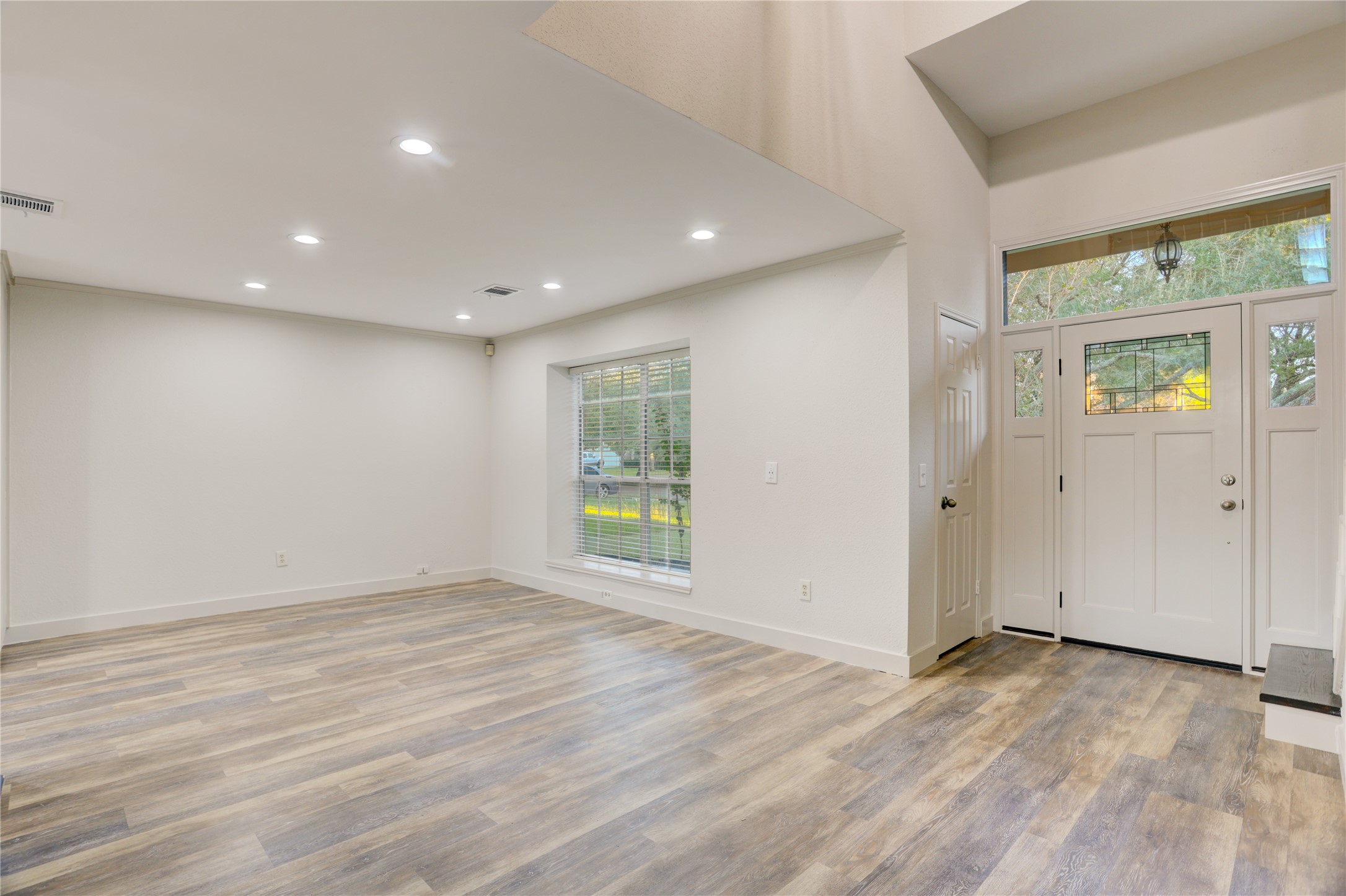 3122 Rimrock Drive Missouri City, TX 77459 - Photo 5 of 29 a view of an empty room with wooden floor and a window