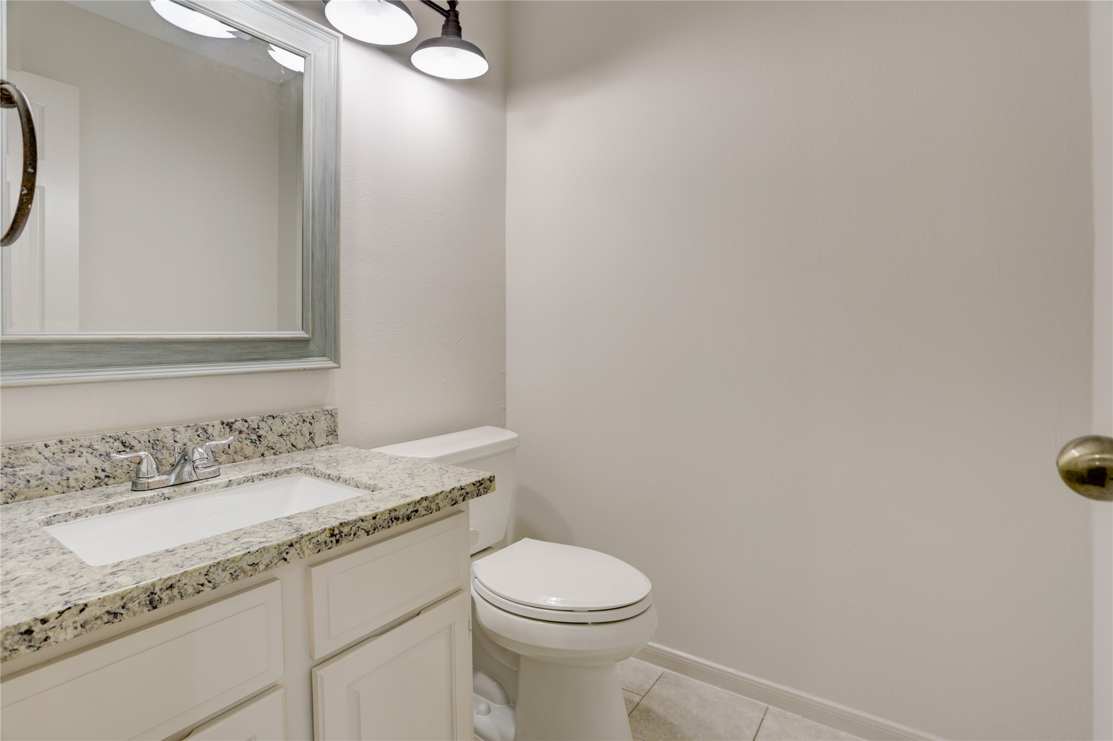 3122 Rimrock Drive Missouri City, TX 77459 - Photo 9 of 29 a bathroom with a granite countertop sink a toilet and a mirror
