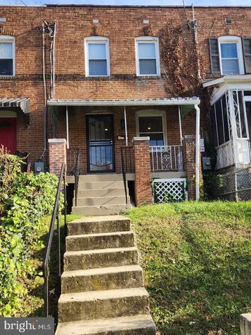 a front view of a house with a garden and plants