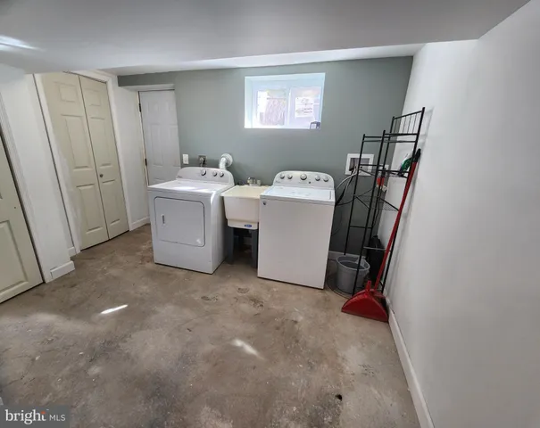 a view of house with backyard and sitting area