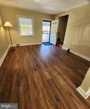 a view of a room with wooden floor and stairs