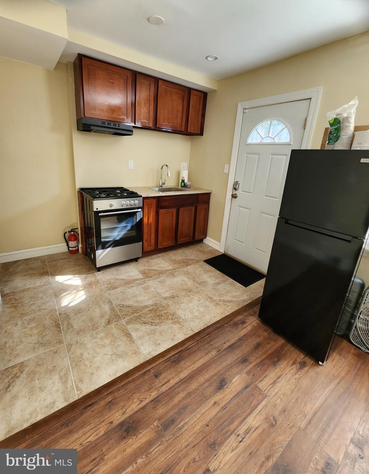 2330 14th Place Southeast Washington, DC 20020 - Photo 4 of 22 a kitchen with a refrigerator and a stove