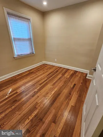 a view of a room with wooden floor and windows