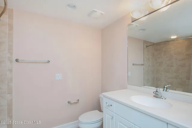 a bathroom with a sink a toilet and vanity