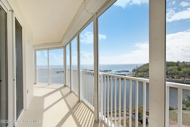 a view of a chairs and table in the balcony