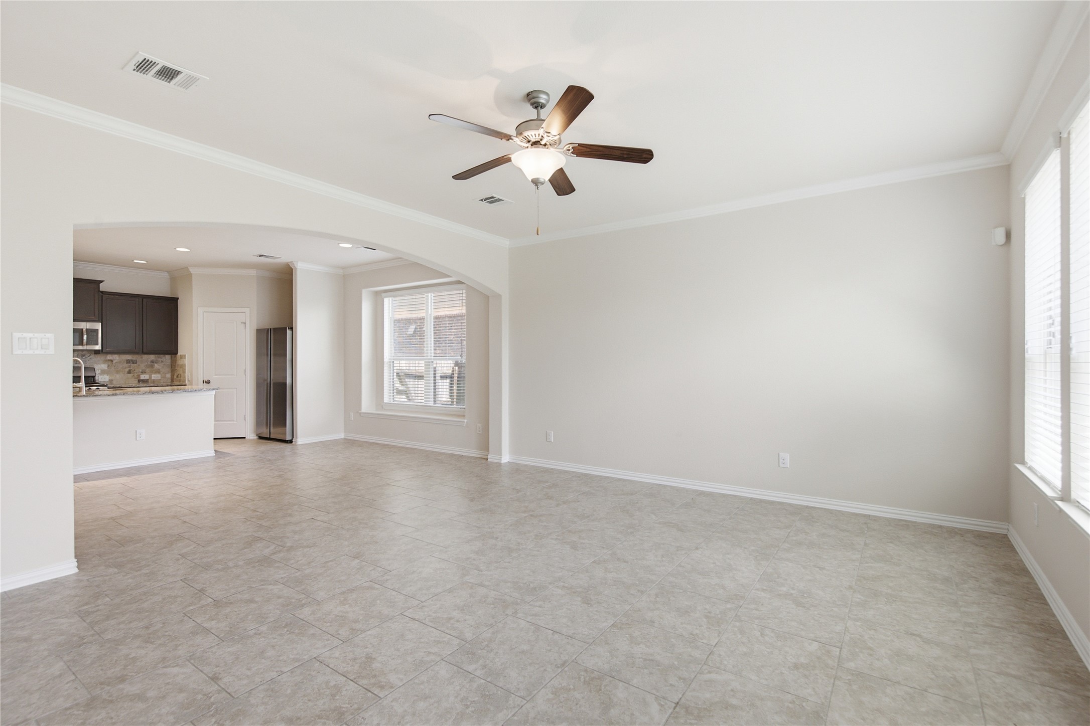 2601 Rough Berry Road Pflugerville, TX 78660 - Photo 17 of 36 An inviting open-concept living space features tiled flooring and an elegant ceiling fan.