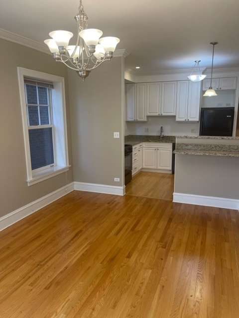 612 Sheridan Road, Unit 1 Evanston, IL 60202 - Photo 13 of 17 a view of kitchen with granite countertop cabinets and wooden floor