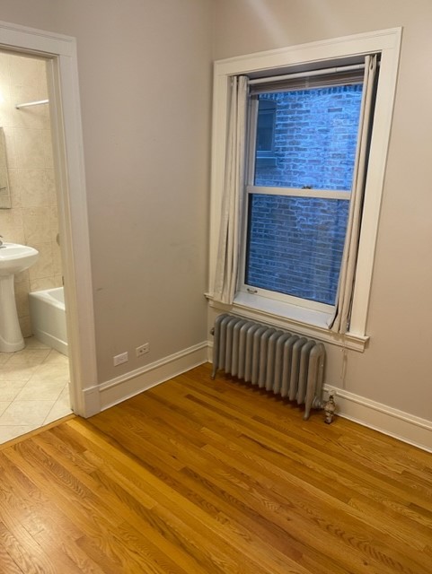 612 Sheridan Road, Unit 1 Evanston, IL 60202 - Photo 15 of 17 a view of an empty room with a window and wooden floor