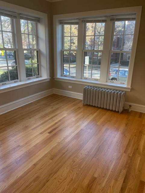 612 Sheridan Road, Unit 1 Evanston, IL 60202 - Photo 4 of 17 a view of an empty room with wooden floor and a window