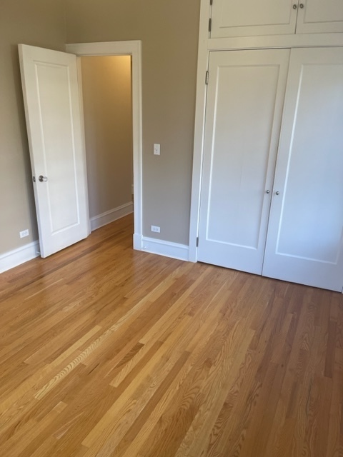 612 Sheridan Road, Unit 1 Evanston, IL 60202 - Photo 5 of 17 an empty room with wooden floor and closet