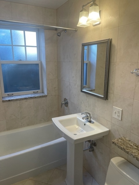 612 Sheridan Road, Unit 1 Evanston, IL 60202 - Photo 6 of 17 a bathroom with a sink and a mirror