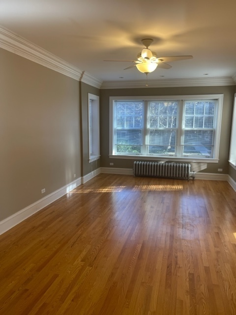 612 Sheridan Road, Unit 1 Evanston, IL 60202 - Photo 7 of 17 wooden floor in an empty room with a window
