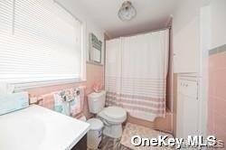 762 Shore Road, Unit LOWR Long Beach, NY 11561 - Photo 11 of 12 a bathroom with a sink and a mirror