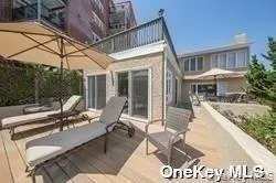 a view of a patio with a dining table and chairs with wooden floor