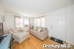 762 Shore Road, Unit LOWR Long Beach, NY 11561 - Photo 4 of 12 a spacious bedroom with a bed and a couch