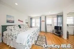 a spacious bedroom with a large bed and a view of bedroom