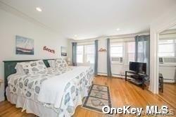762 Shore Road, Unit LOWR Long Beach, NY 11561 - Photo 9 of 12 a spacious bedroom with a large bed and a view of bedroom