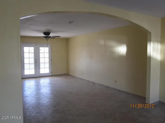 an empty room with windows and entrance