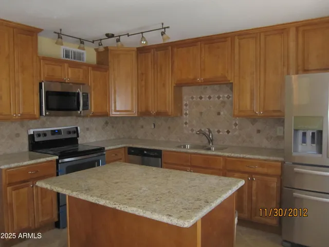 a kitchen with a stove a sink and a microwave