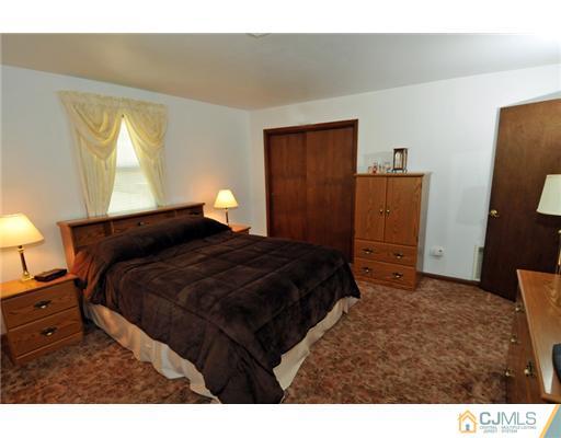 44 Idlewild Road Edison, NJ 08817 - Photo 13 of 15 a bedroom with a bed and a cabinets