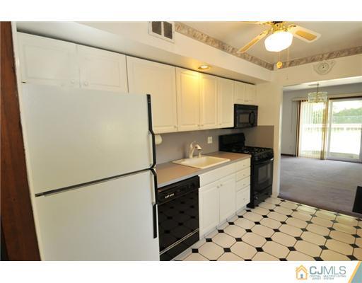 44 Idlewild Road Edison, NJ 08817 - Photo 6 of 15 a kitchen with a refrigerator and a sink