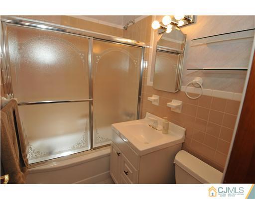 44 Idlewild Road Edison, NJ 08817 - Photo 7 of 15 a bathroom with a sink a mirror and a shower