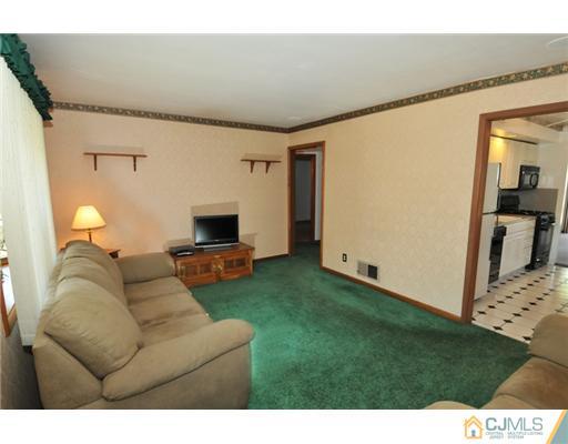 44 Idlewild Road Edison, NJ 08817 - Photo 10 of 15 a living room with furniture and a fireplace