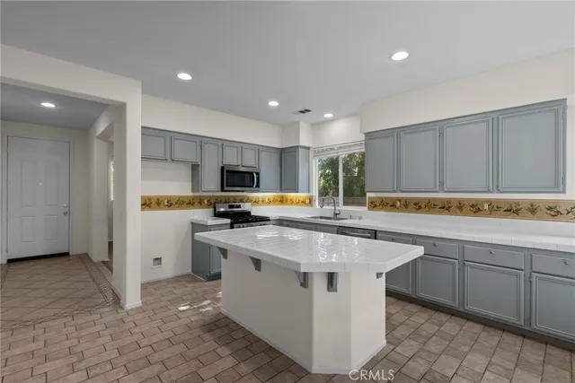 a kitchen with sink cabinets and stainless steel appliances