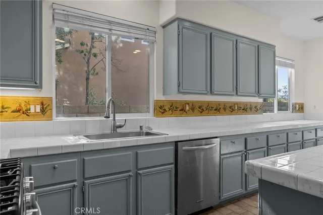 a kitchen with a sink and a wooden cabinets