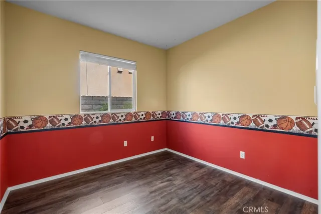 a view of a room with wooden floor and bench