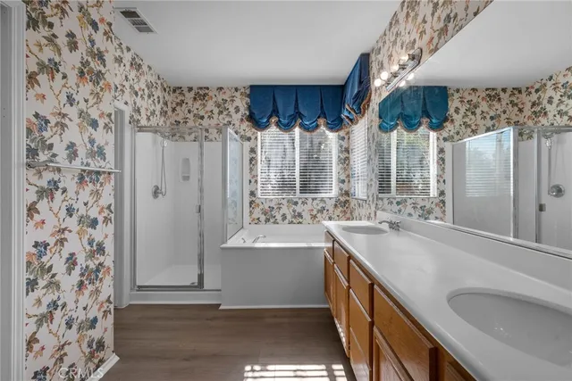 a bathroom with a double vanity sink mirror and shower