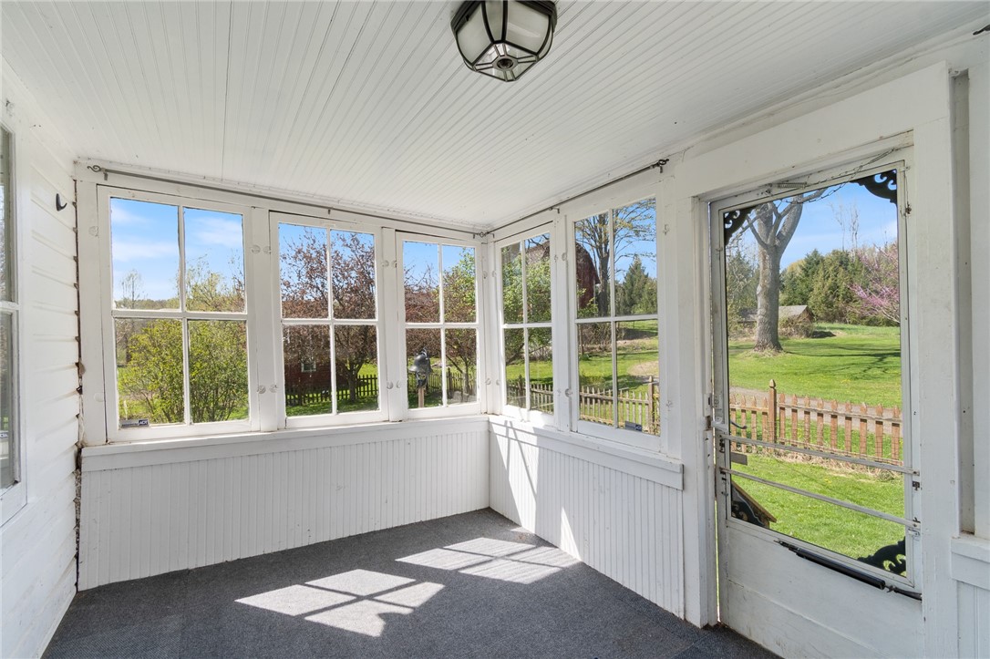 4427 Boynton Road Walworth, NY 14568 - Photo 6 of 49 The enclosed side porch that opens to the kitchen-